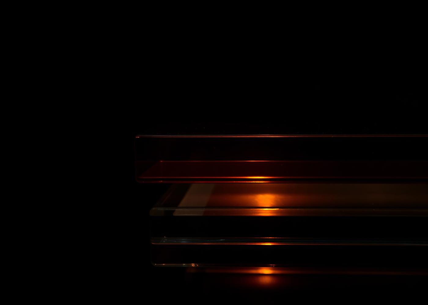 Layered translucent planes lit with a copper glow, representing the group's technology stack